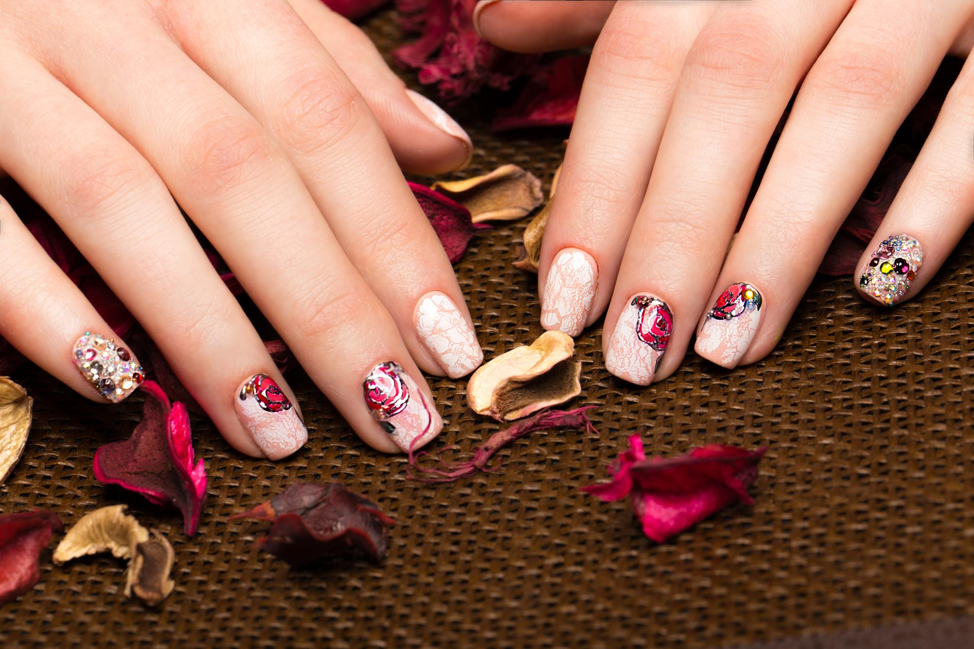 beautiful-manicure-with-flowers-female-fingers-nails-design-closeup-picture-taken-studio-white-background
